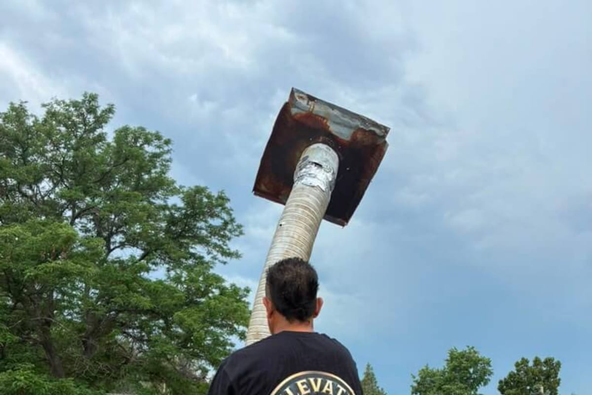The rusted top plate on a Boulder chimney flue pipe, invisible from the ground until the crew brought it down